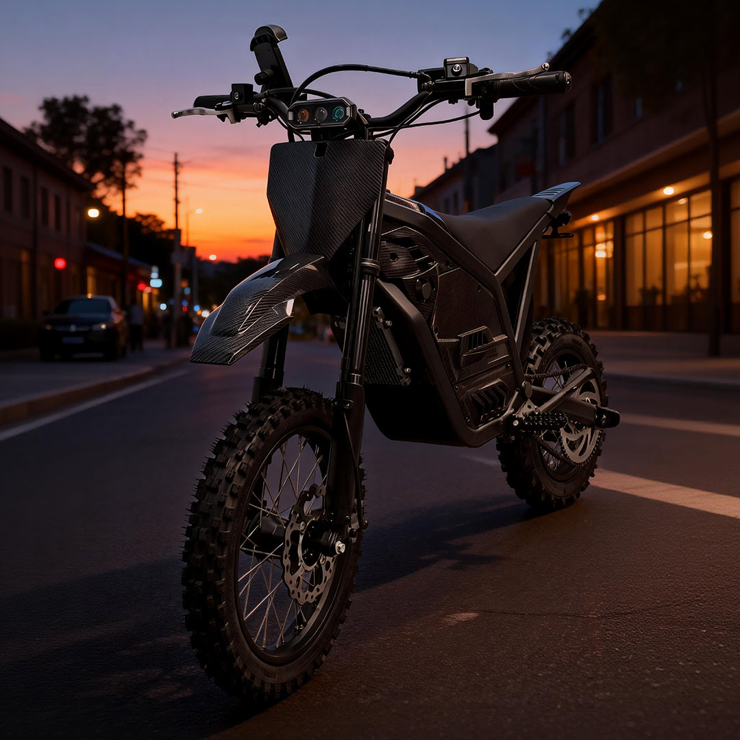 Electric motorcycle front end with knobby tires and headlight on at dusk